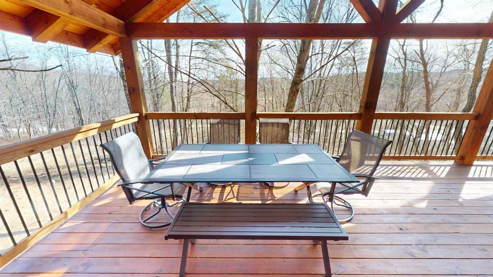 willifeesp-mar26-24 Interior stone fireplace with a flickering fire in the Wildlife Escape cabin.